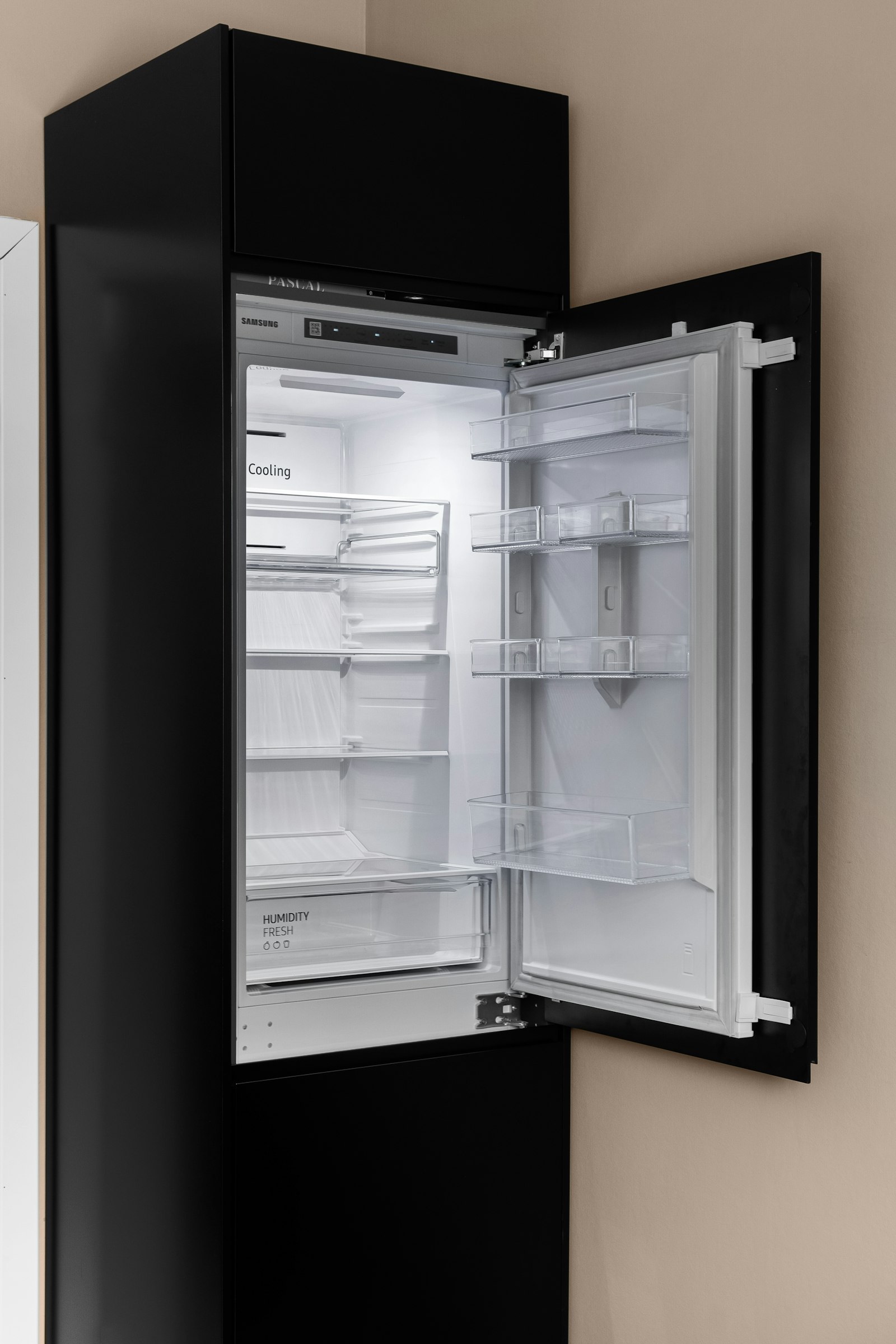 Black refrigerator with its door open in a modern kitchen