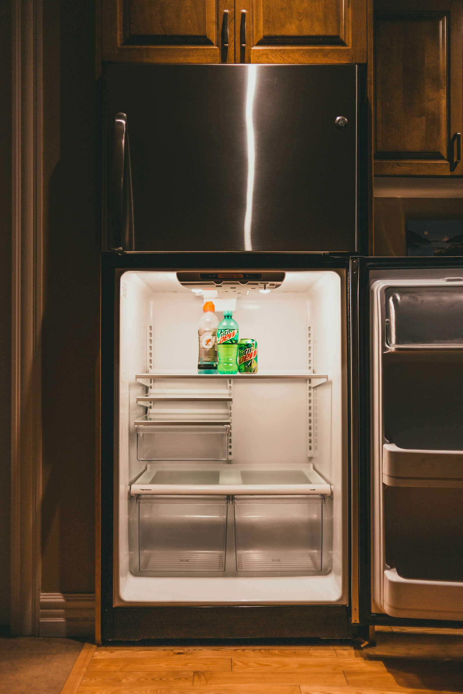 Black top-mount refrigerator with a water dispenser in a kitchen
